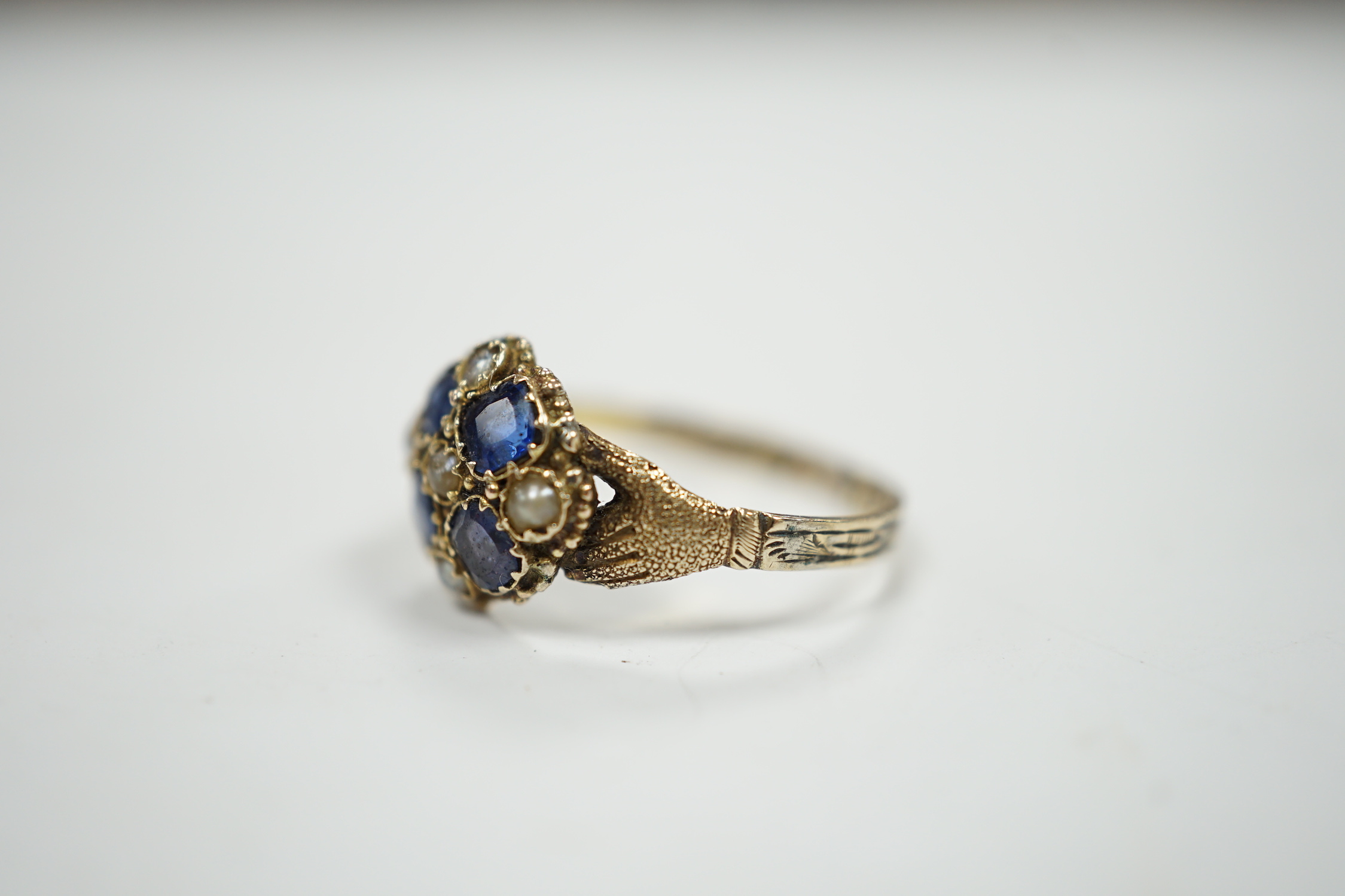 A Victorian 12ct gold sapphire and seed pearl cluster set ring, size M, gross weight 1.6 grams.